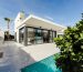 White and grey concrete building near swimming pool under clear sky during daytime